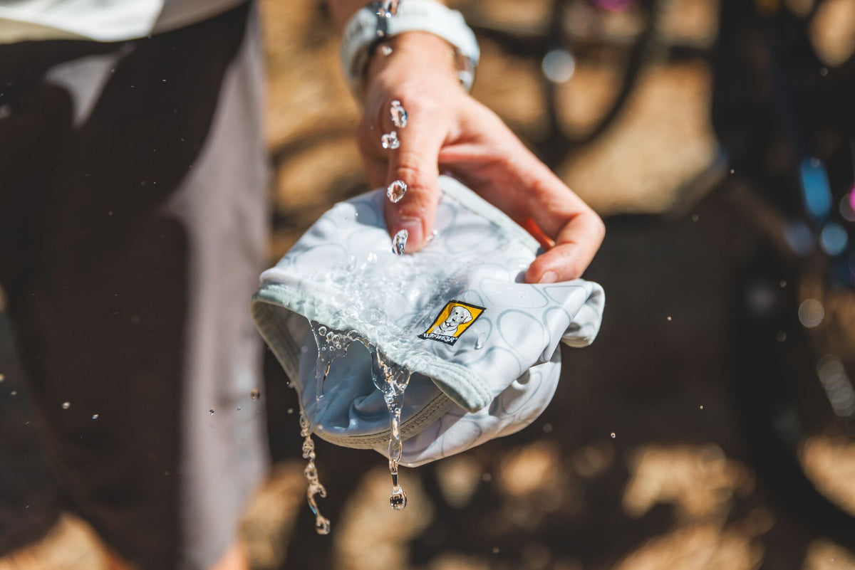 Person soaking Ruffwear Swamp Cooler Neck Gaiter in water
